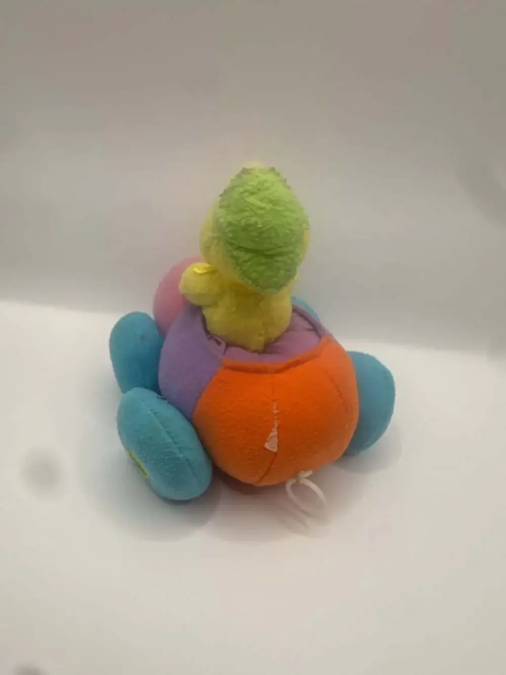Vintage Pull-Back Toy Chick Driving a Multi-Colored Plush Bumper Car